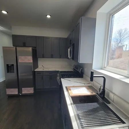 a kitchen with a refrigerator and a sink