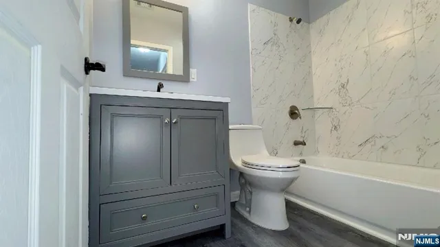 a bathroom with a toilet sink and mirror
