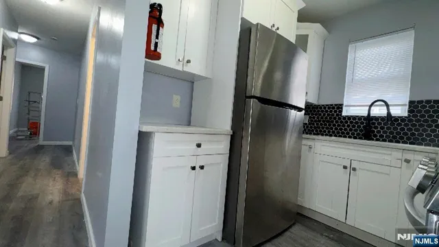 a kitchen with a refrigerator and a sink
