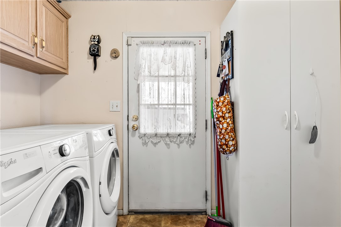 1545 East El Rodeo Road, Unit 58 Fort Mohave, AZ 86426 - Photo 19 of 47 Laundry area with cabinet space and washer and clothes dryer