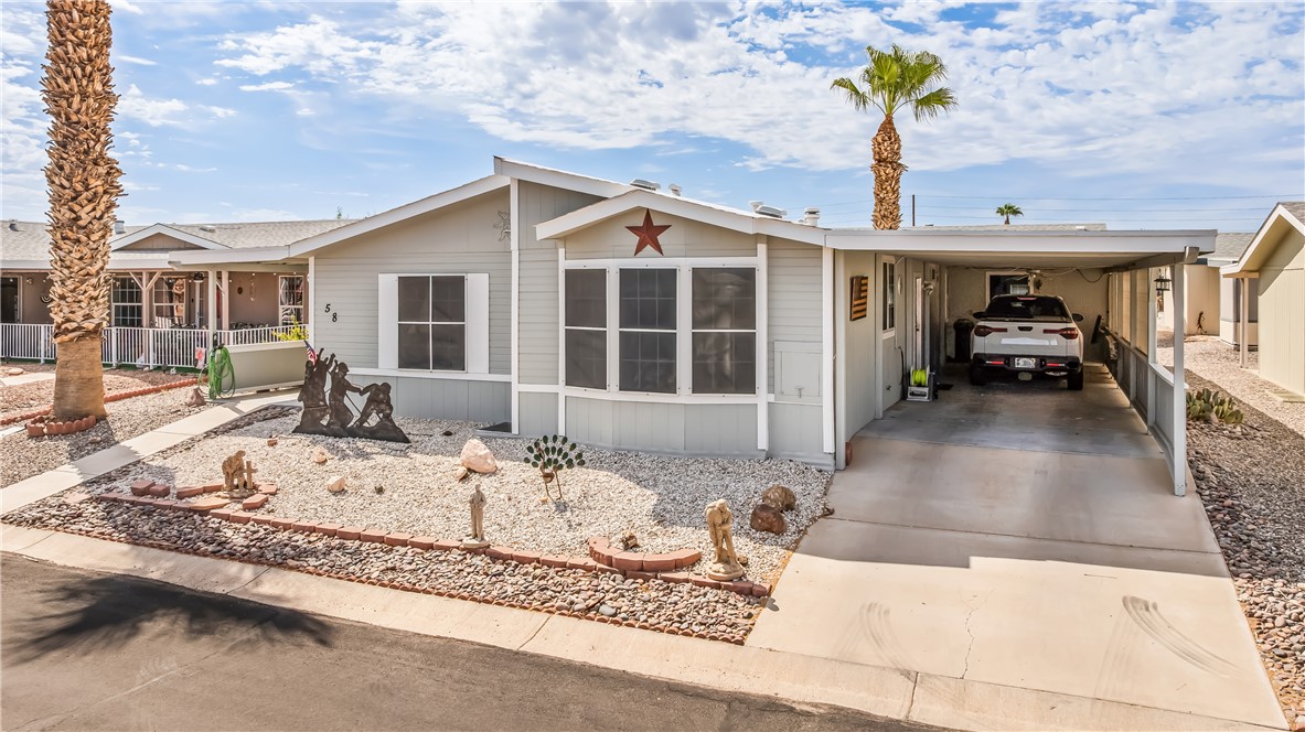 1545 East El Rodeo Road, Unit 58 Fort Mohave, AZ 86426 - Photo 2 of 47 Manufactured / mobile home with driveway and a carport