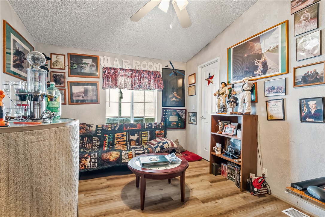1545 East El Rodeo Road, Unit 58 Fort Mohave, AZ 86426 - Photo 26 of 47 Sitting room featuring wood finished floors, a textured ceiling, a ceiling fan, and a textured wall