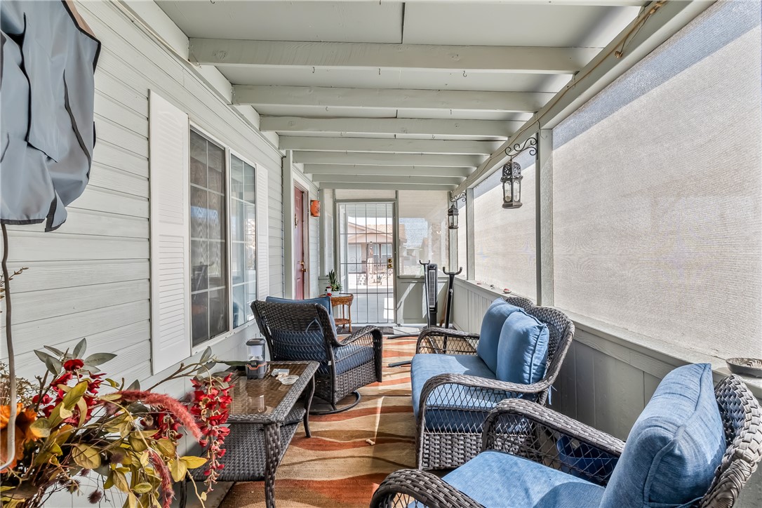 1545 East El Rodeo Road, Unit 58 Fort Mohave, AZ 86426 - Photo 31 of 47 Sunroom featuring beamed ceiling and an outdoor hangout area