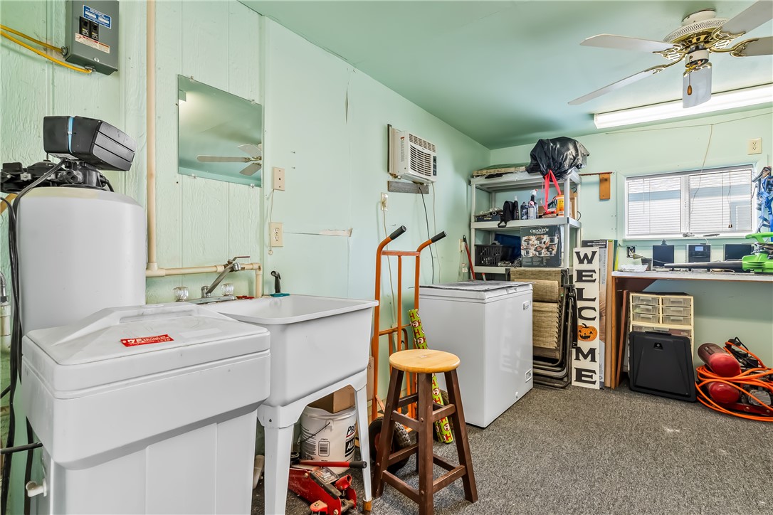 1545 East El Rodeo Road, Unit 58 Fort Mohave, AZ 86426 - Photo 34 of 47 Laundry room with ceiling fan, carpet, and a wall mounted air conditioner