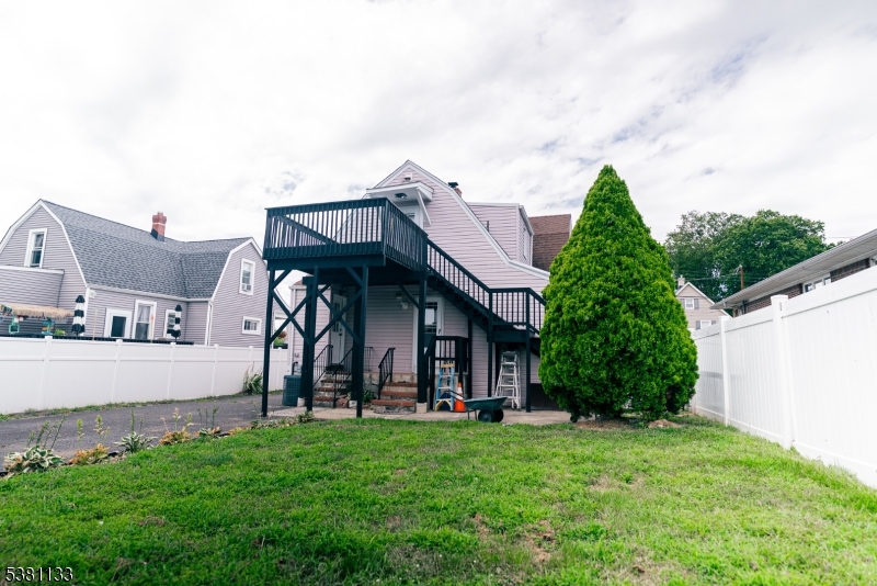 88 Hornsby Street Woodbridge, NJ 08863 - Photo 11 of 12 a view of a house with brick walls and a yard with plants