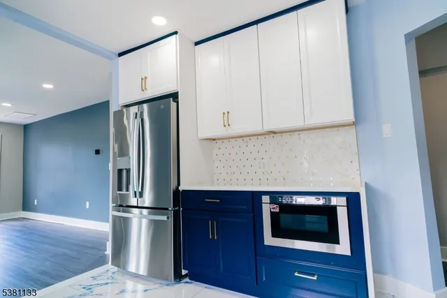 a kitchen with a refrigerator and a stove top oven