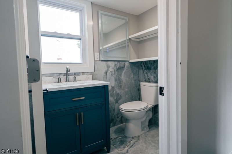 88 Hornsby Street Woodbridge, NJ 08863 - Photo 6 of 12 a bathroom with a sink toilet and a window