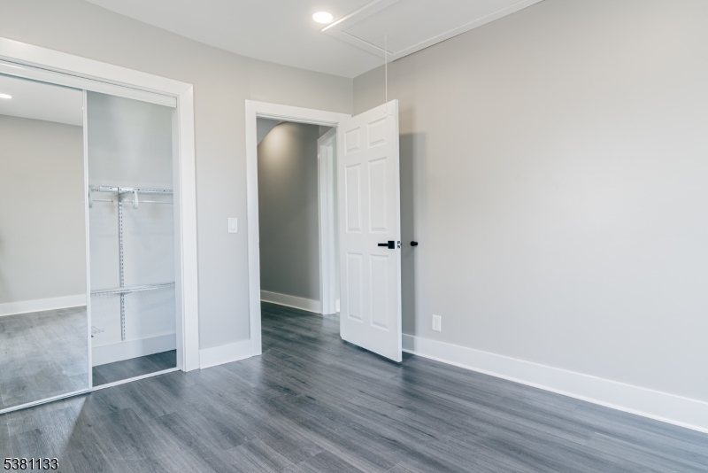 88 Hornsby Street Woodbridge, NJ 08863 - Photo 8 of 12 an empty room with wooden floor