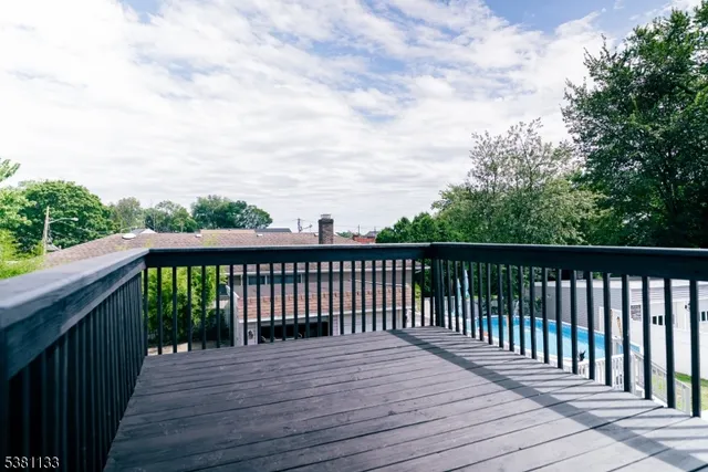 a balcony with wooden floor and fence