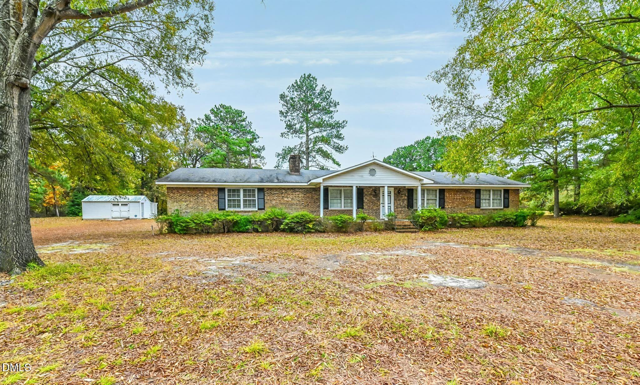 3011 Will Lucas Road Linden, NC 28356 - Photo 2 of 35 a front view of a house with a yard and trees