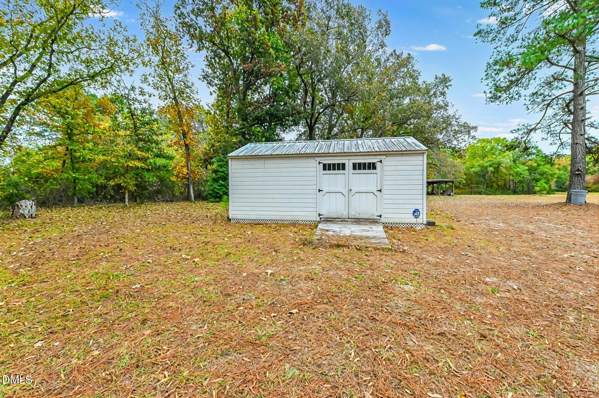 3011 Will Lucas Road Linden, NC 28356 - Photo 33 of 35 a backyard of a house with plants and large trees
