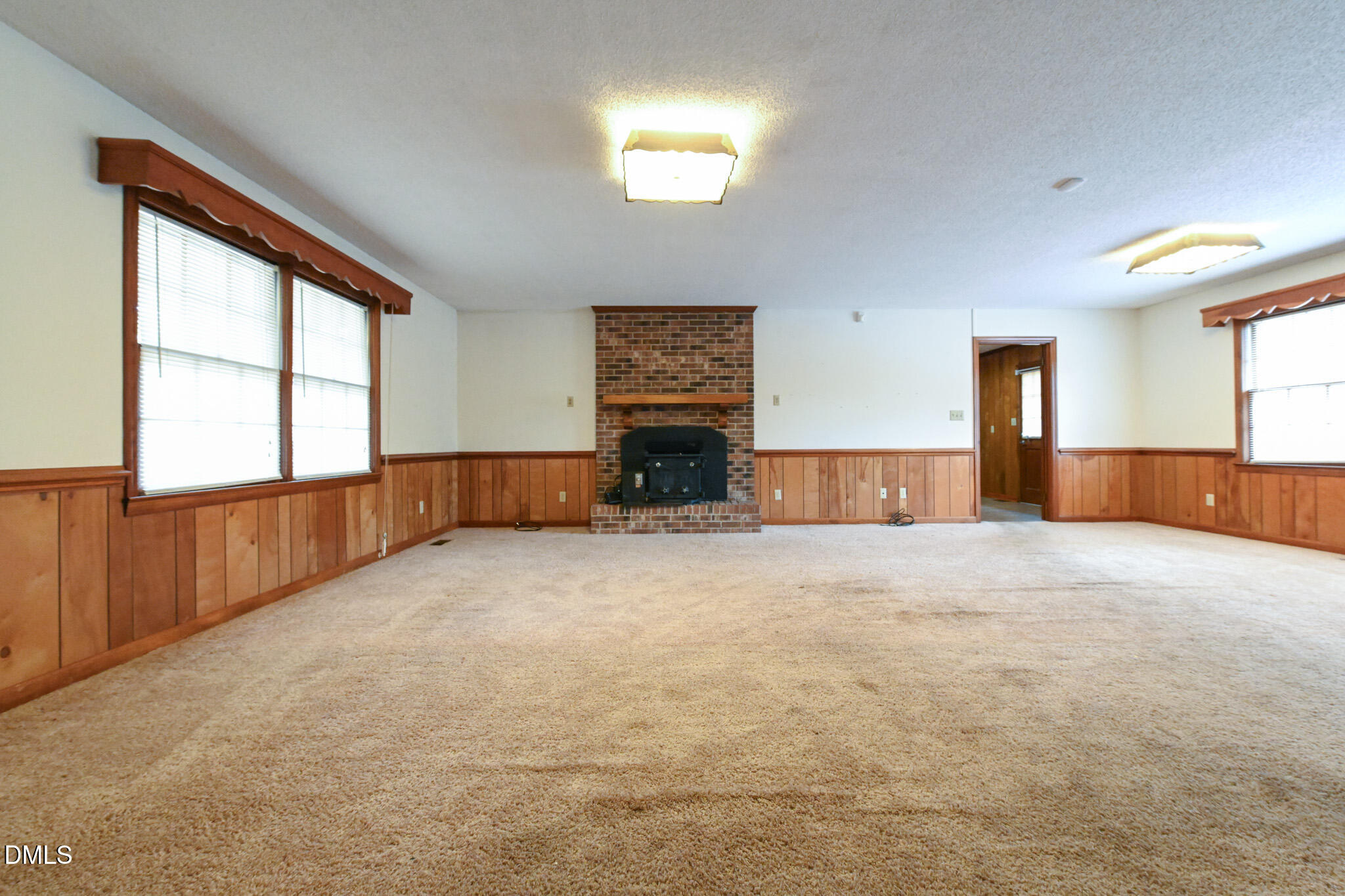 3011 Will Lucas Road Linden, NC 28356 - Photo 6 of 35 an empty room with windows and fireplace