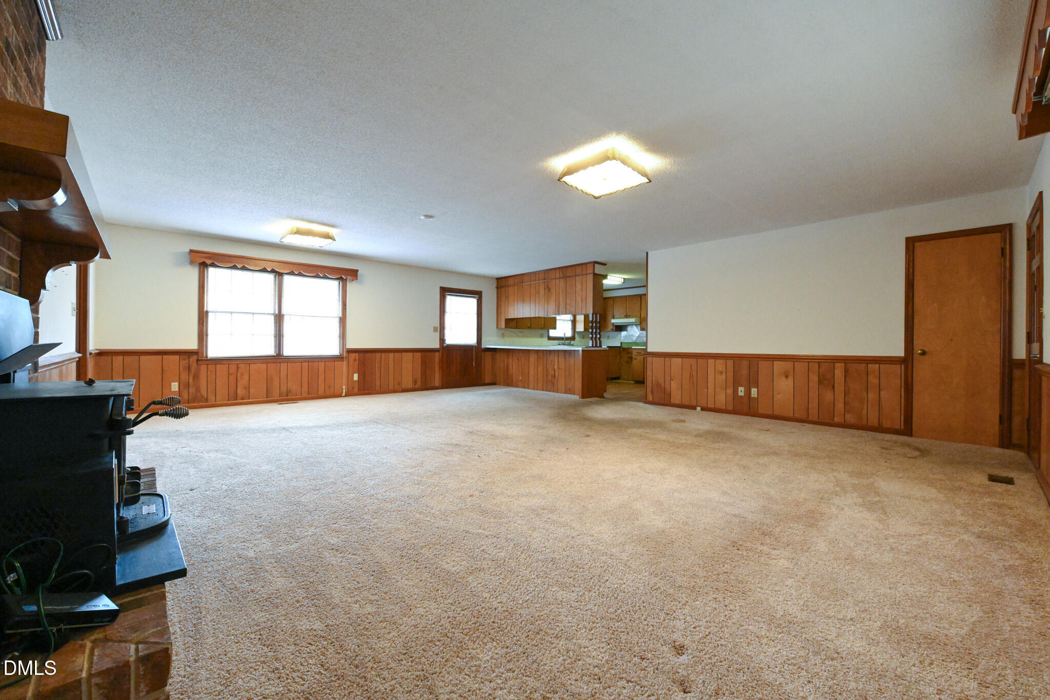 3011 Will Lucas Road Linden, NC 28356 - Photo 7 of 35 an empty room with a fireplace and window