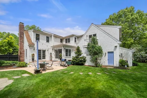 a front view of house with a garden and patio