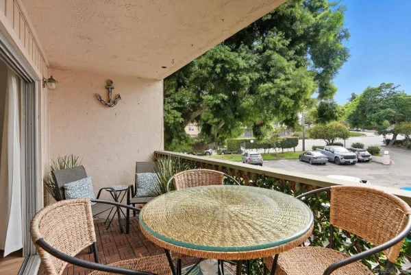a balcony with table and chairs