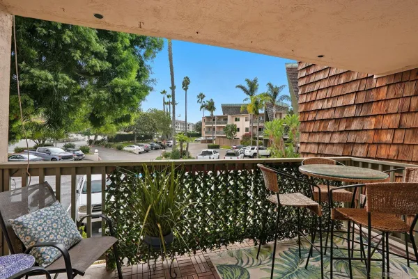 a balcony with table and chairs