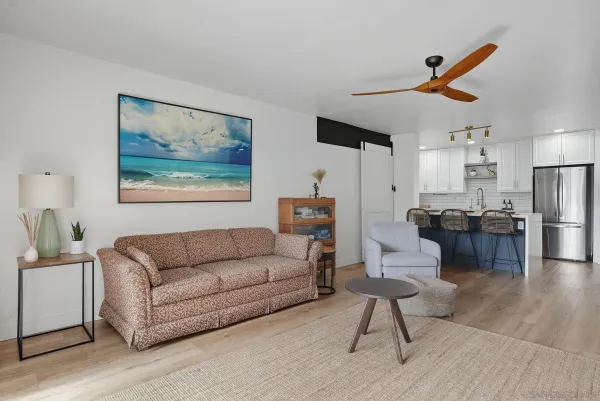 a living room with furniture and kitchen view
