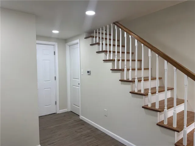 wooden floor in an empty room with stairs