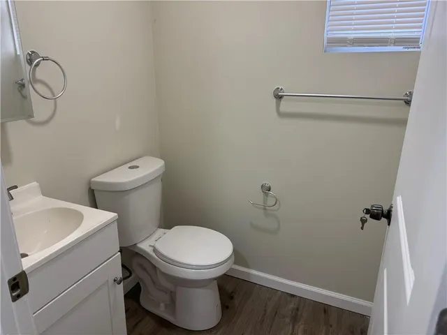 a white toilet sitting next to a bathroom sink