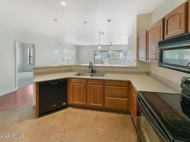 a kitchen with a sink stove and microwave