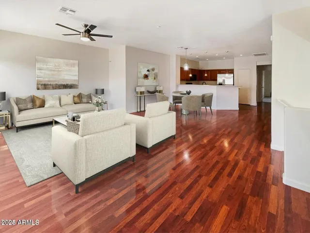 a living room with furniture and a wooden floor