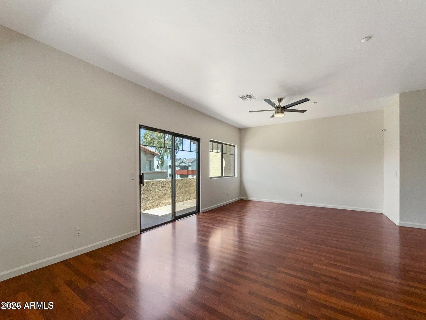 805 South Sycamore, Unit 222 Mesa, AZ 85202 - Photo 8 of 10 a view of an empty room with wooden floor and a window