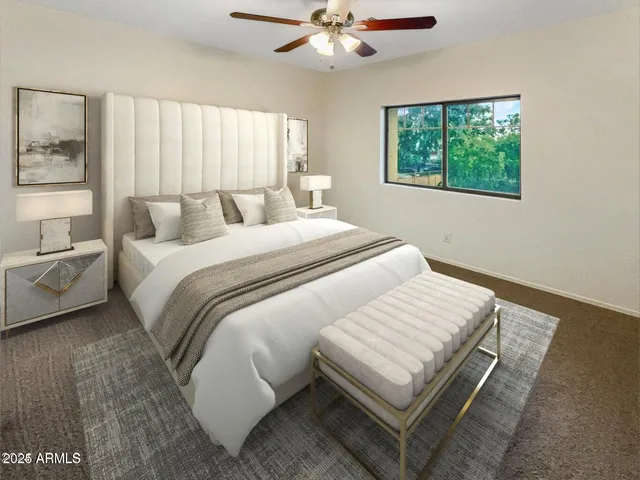 a bed sitting in a bedroom next to a window