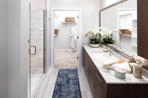 a bathroom with a sink vanity granite tub and shower