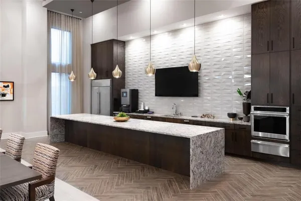 a kitchen with stainless steel appliances wooden cabinets a sink and a stove
