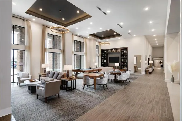 a living room with lots of furniture and a large window