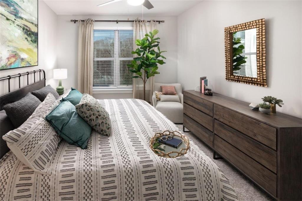 1927 Powers Ferry Road, Unit 317 Atlanta, GA 30339 - Photo 10 of 33 a bedroom with a bed and a window