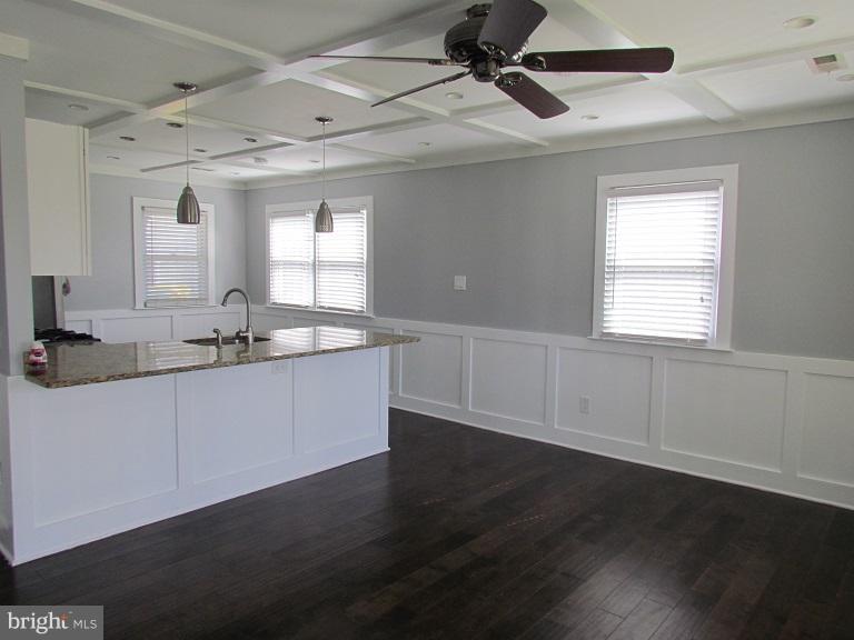 772 223rd Street Pasadena, MD 21122 - Photo 3 of 13 a large kitchen with wooden floor