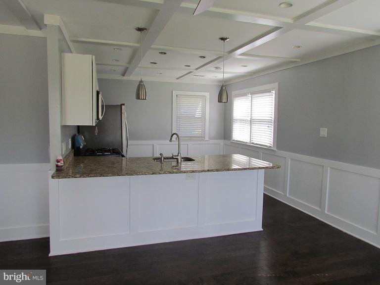 772 223rd Street Pasadena, MD 21122 - Photo 4 of 13 a large white kitchen with a large window
