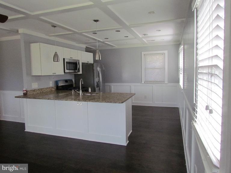 772 223rd Street Pasadena, MD 21122 - Photo 5 of 13 a room with kitchen island a sink wooden floor and a window