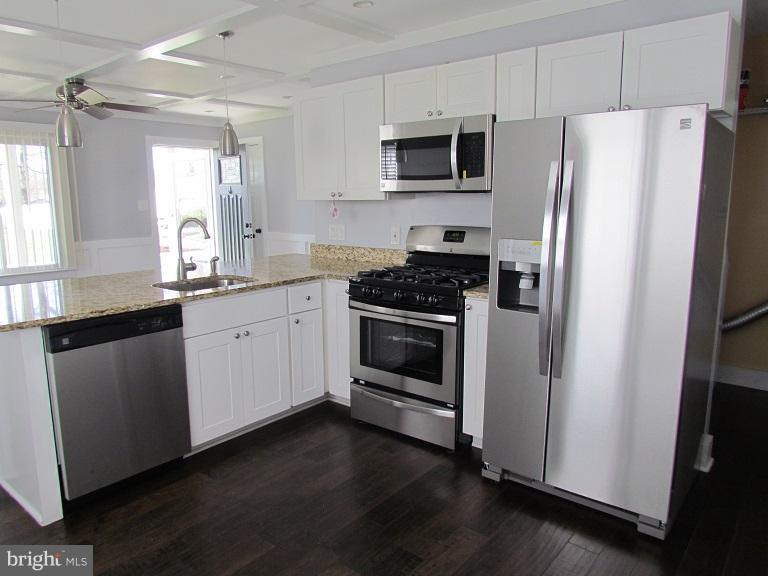 772 223rd Street Pasadena, MD 21122 - Photo 7 of 13 a kitchen with stainless steel appliances a refrigerator sink and microwave