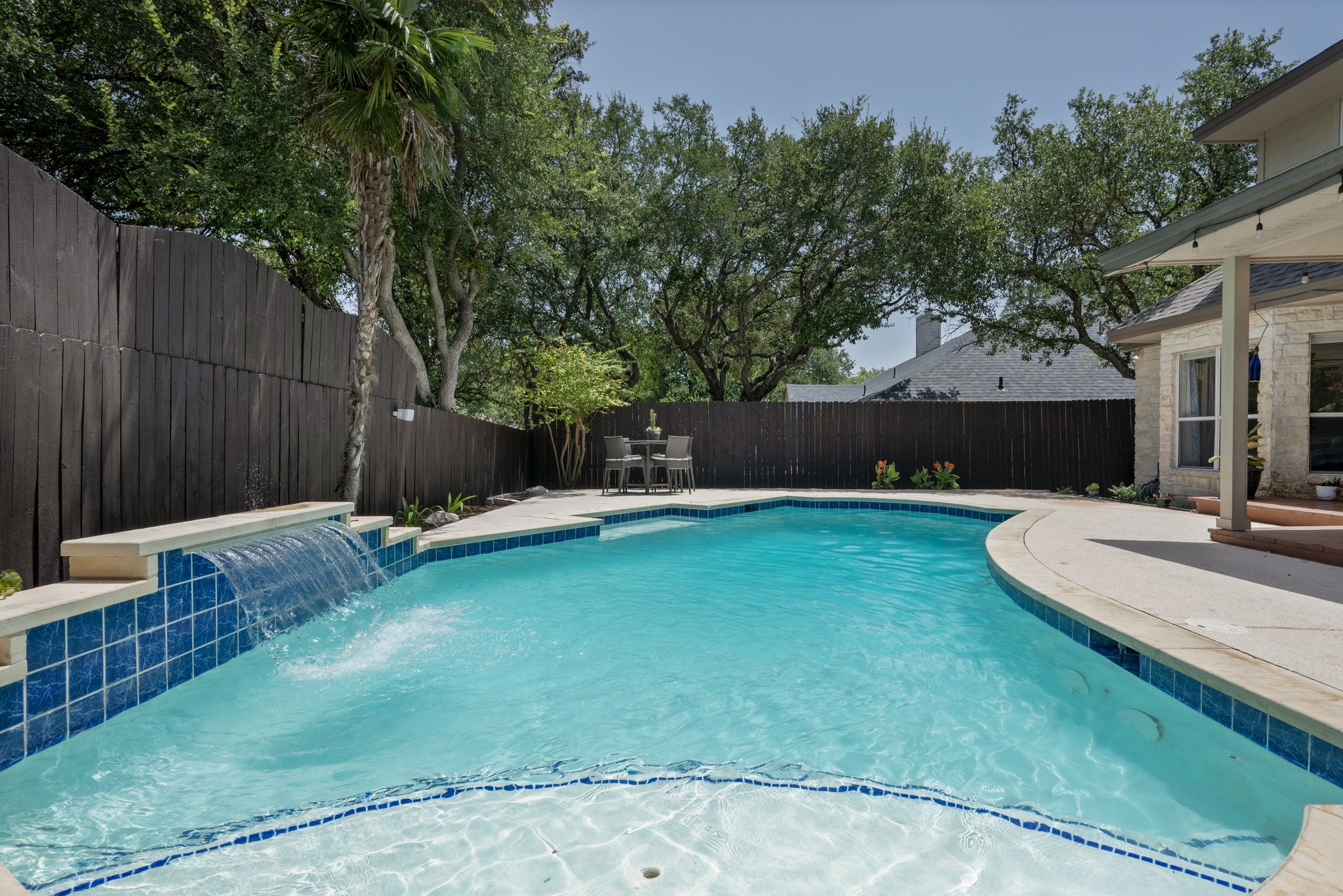 108 Thornwood Road Georgetown, TX 78628 - Photo 36 of 40 A tranquil backyard oasis features a free-form pool with a graceful waterfall feature and ample patio space.