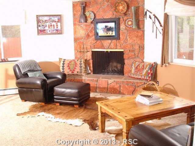 921 West Cheyenne Road Colorado Springs, CO 80906 - Photo 4 of 14 Wood burning fireplace, new vinyl windows