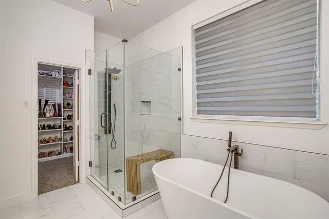 a bathroom with a bathtub and a shower