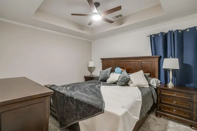 a bedroom with a bed and a lamp