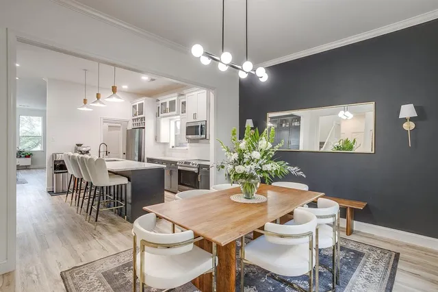 a view of a dining room with furniture and chandelier