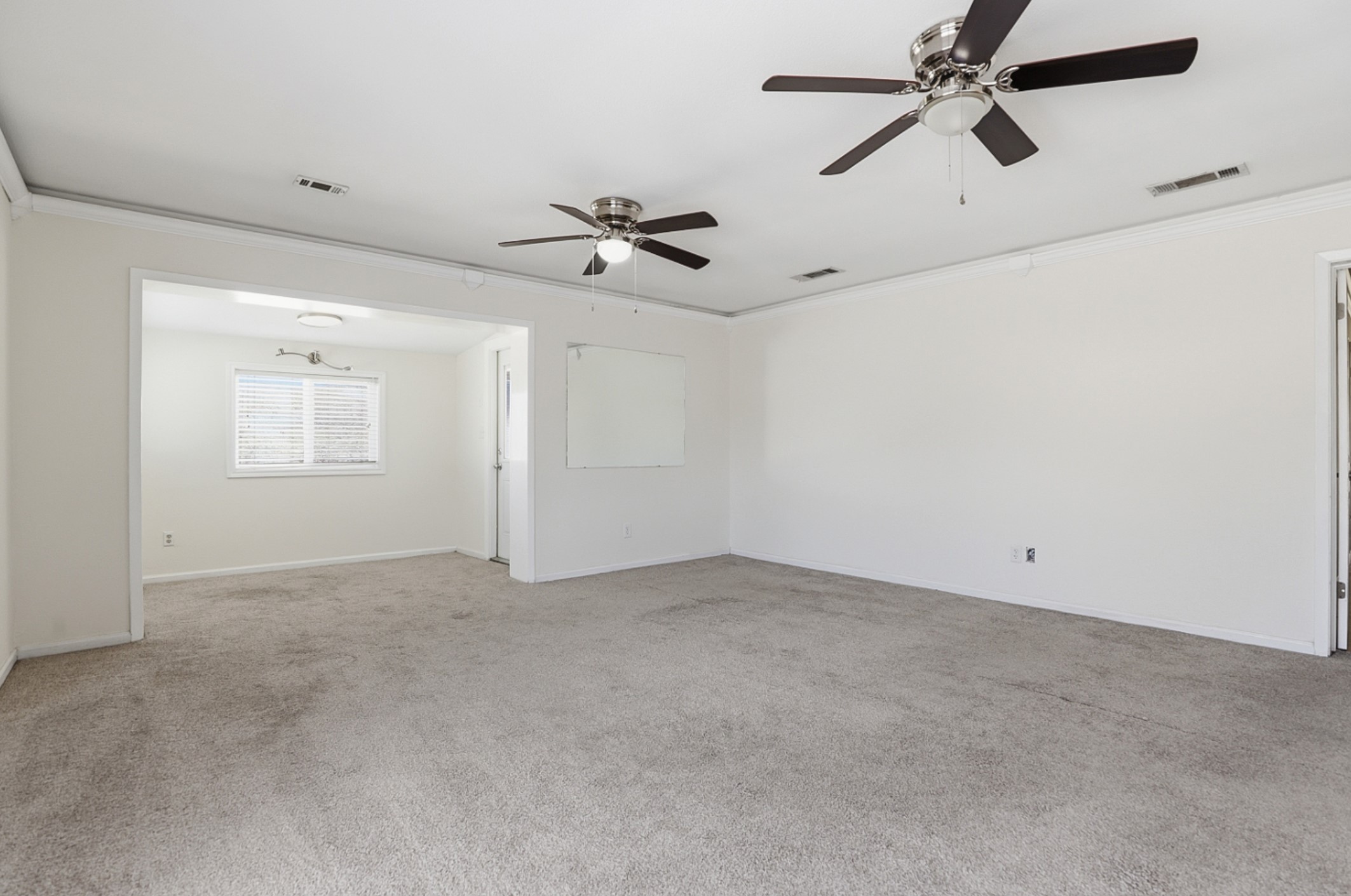 128 Skyview Terrace Leander, TX 78641 - Photo 11 of 23 Primary bedroom with light colored carpet, crown molding, and dual ceiling fans.