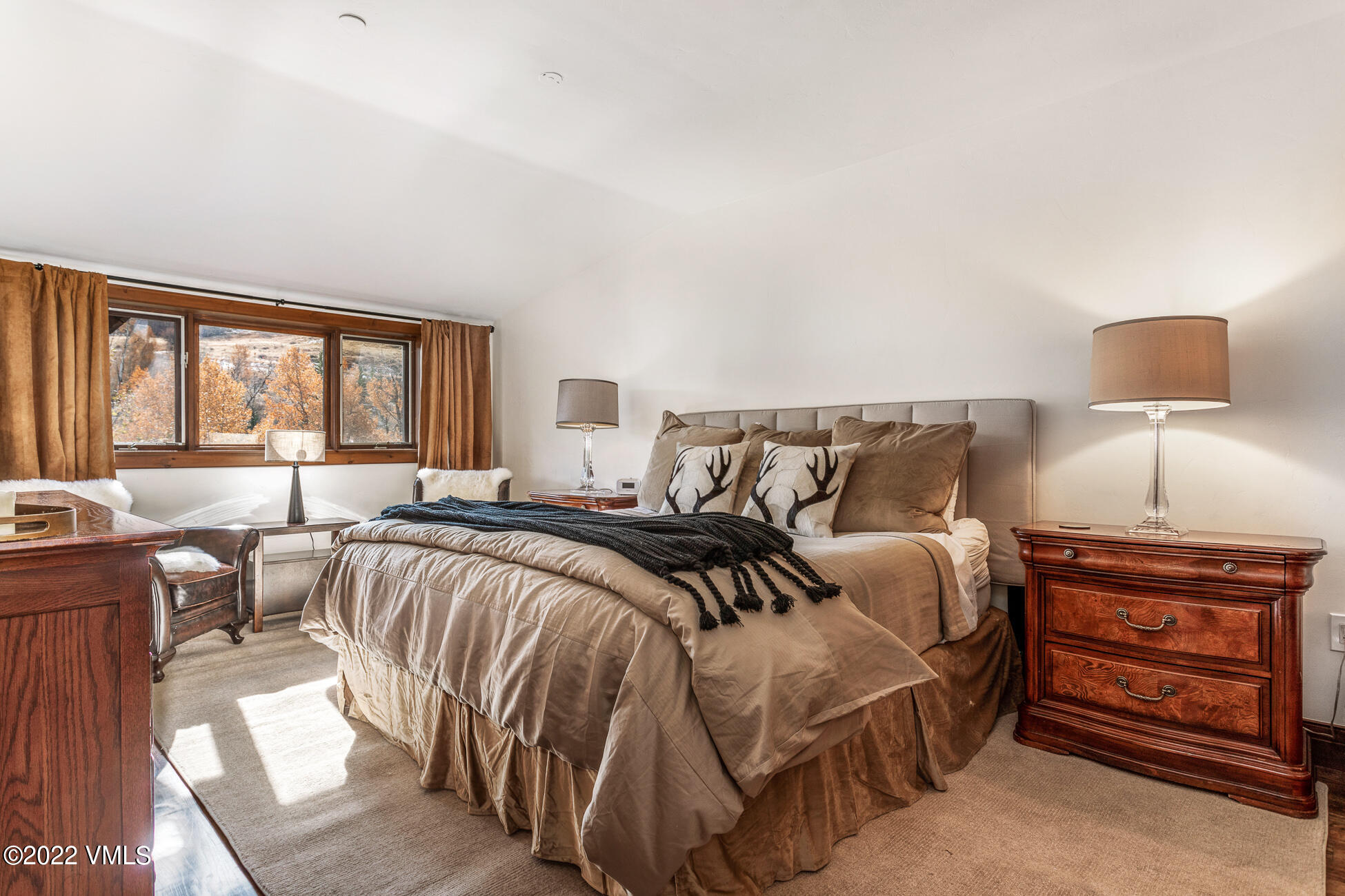 180 Daybreak Ridge Road, Unit 813 Avon, CO 81620 - Photo 14 of 46 a bedroom with a bed and wooden floor