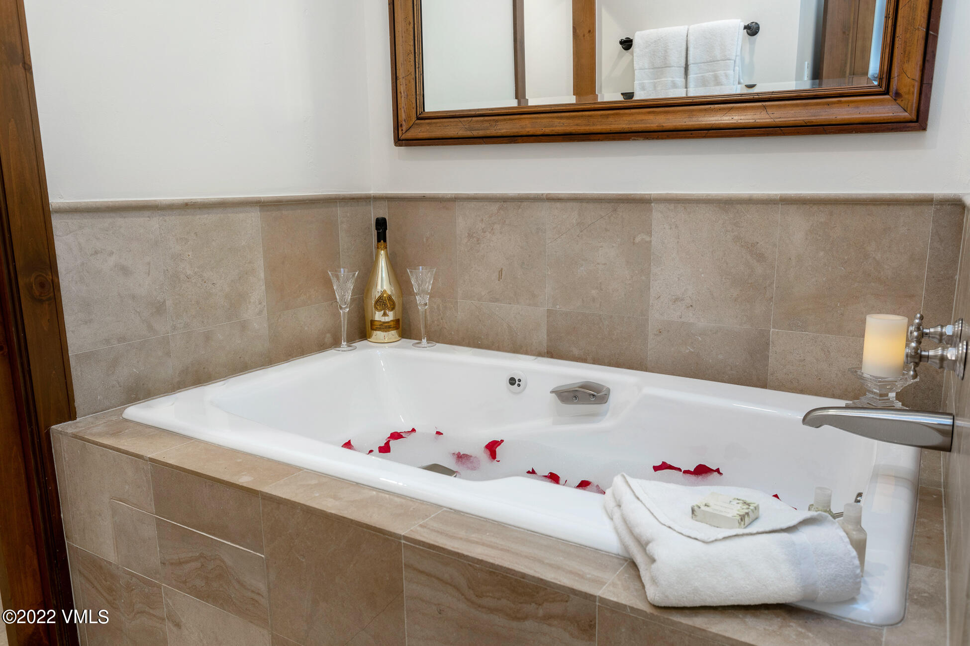 180 Daybreak Ridge Road, Unit 813 Avon, CO 81620 - Photo 17 of 46 a bathroom with a bathtub and a window