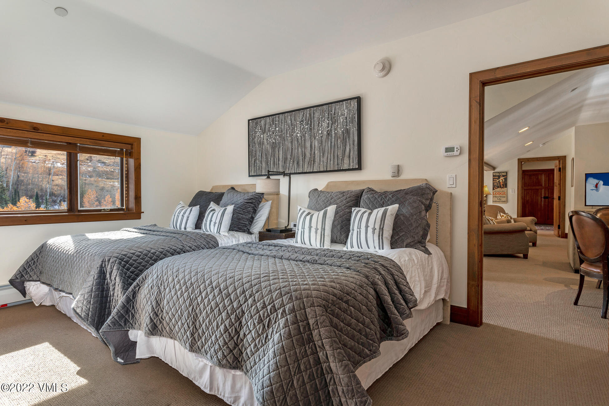 180 Daybreak Ridge Road, Unit 813 Avon, CO 81620 - Photo 33 of 46 a spacious bedroom with a bed and glass windows
