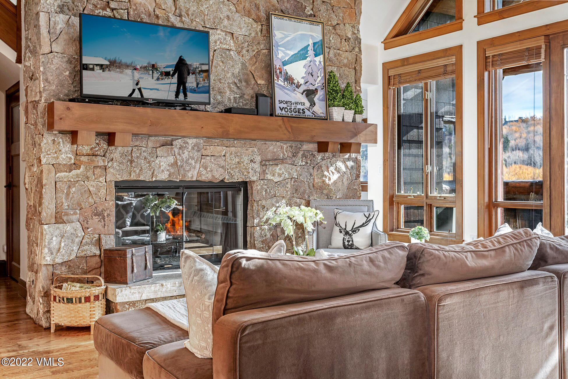 180 Daybreak Ridge Road, Unit 813 Avon, CO 81620 - Photo 4 of 46 a living room with furniture a fireplace and a floor to ceiling window