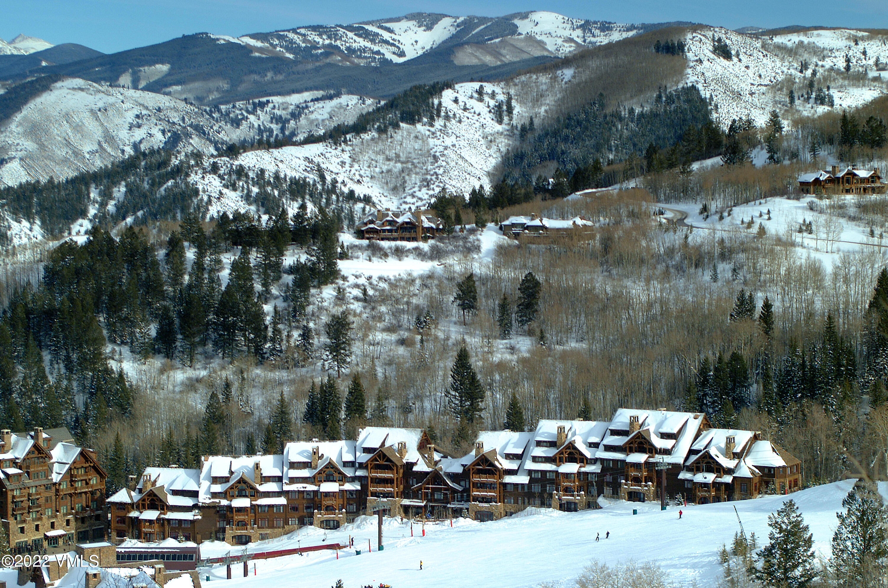 180 Daybreak Ridge Road, Unit 813 Avon, CO 81620 - Photo 41 of 46 a view of a lake with couches and a fire pit