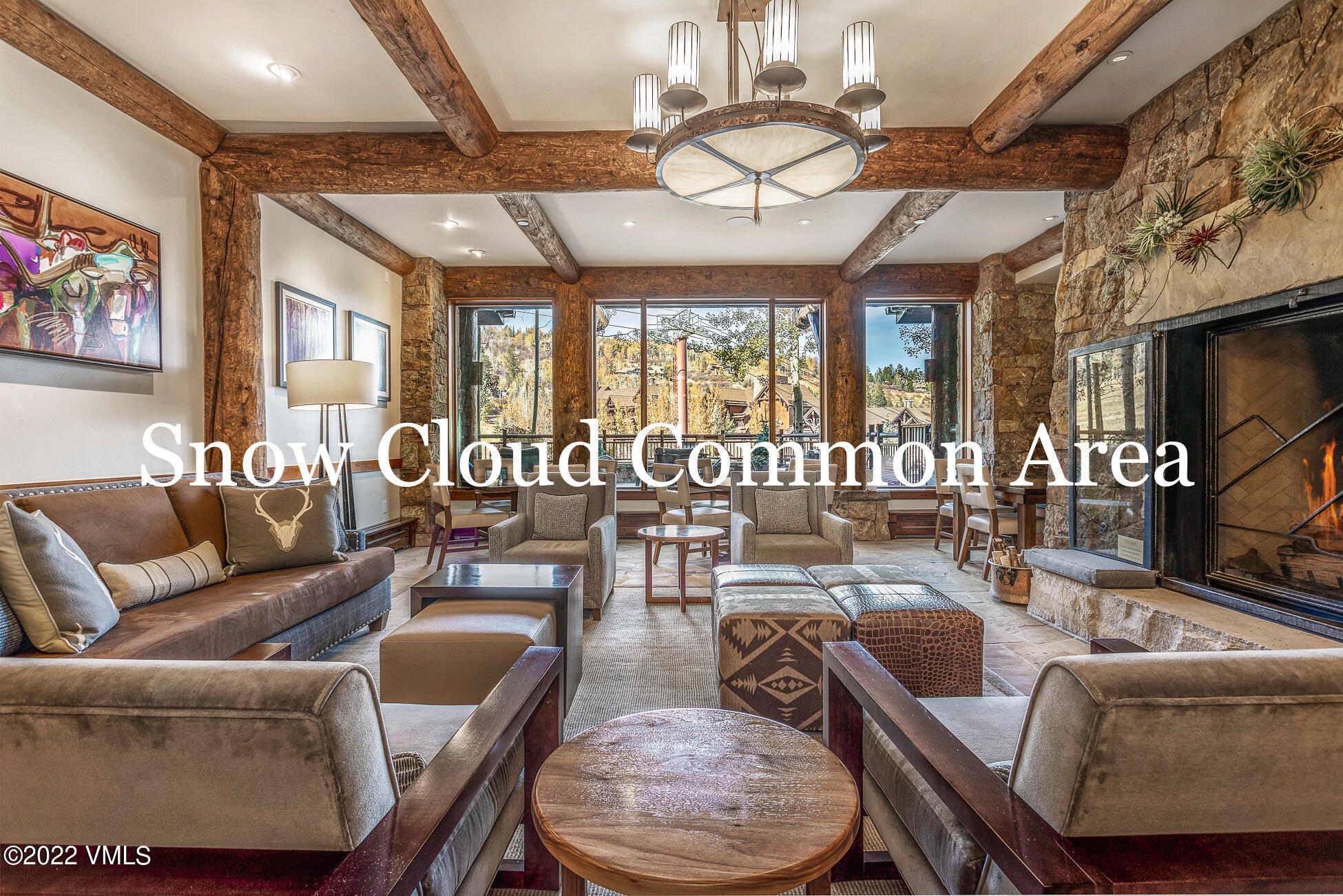 180 Daybreak Ridge Road, Unit 813 Avon, CO 81620 - Photo 43 of 46 a living room with furniture a chandelier and a large window