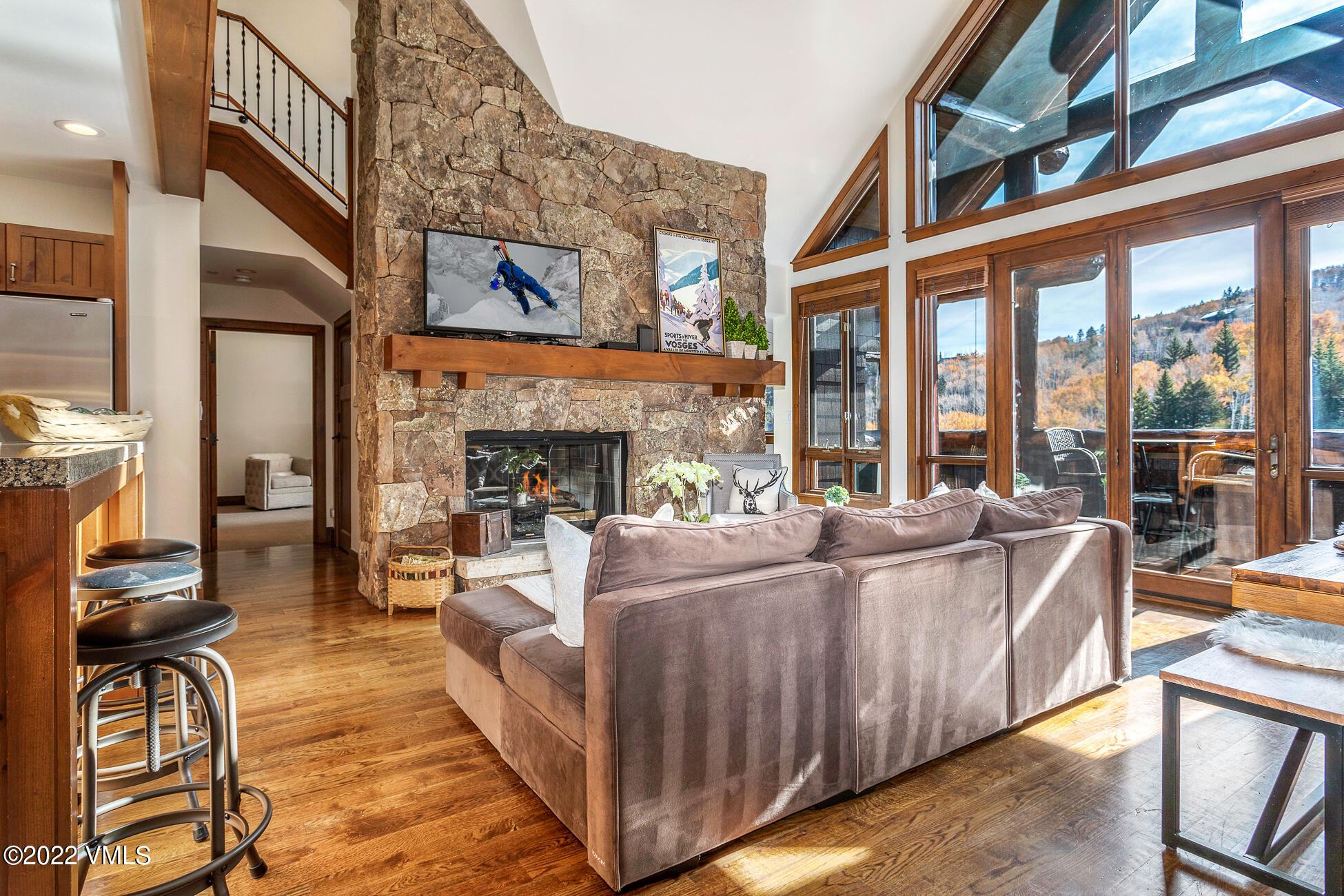 180 Daybreak Ridge Road, Unit 813 Avon, CO 81620 - Photo 5 of 46 a living room with furniture a fireplace and a floor to ceiling window