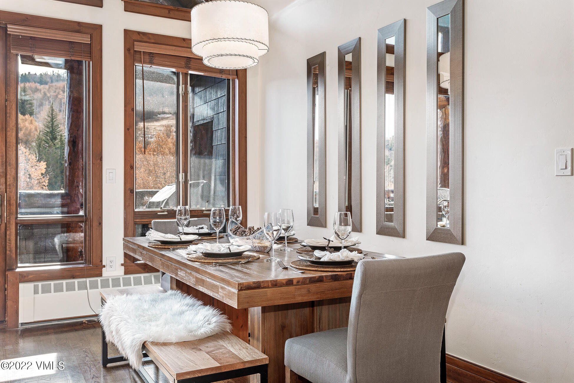180 Daybreak Ridge Road, Unit 813 Avon, CO 81620 - Photo 9 of 46 a dining room with furniture and large windows