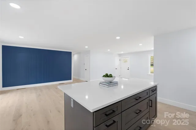 a kitchen with a sink cabinets and wooden floor